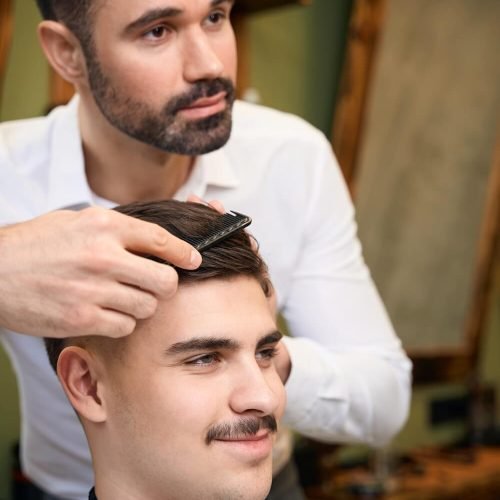 man-hairstylist-serving-client-with-mustache-2025-03-08-15-34-48-utc.jpg